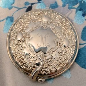 Silver plated compact mirror. This is unused, and engraved with a letter “m”.